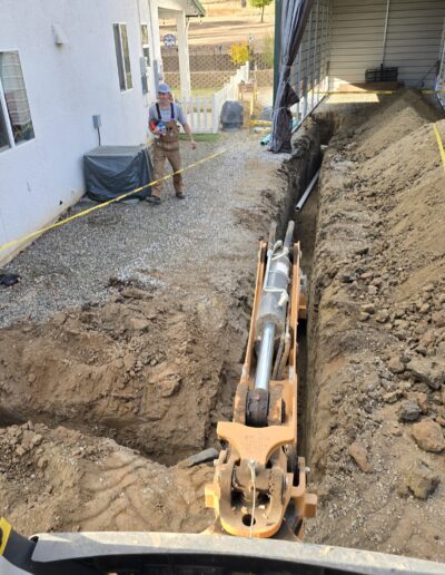 Close-up of RV valves and rock leach line addition, showing the detailed installation of valves and rock-filled drainage lines