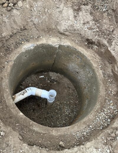 Completed dry well drop tee installation, showing the tee fully connected to the drainage system and ready for use