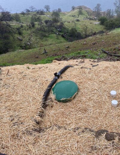 New tank installation, showing the newly placed tank and connection to plumbing or septic system